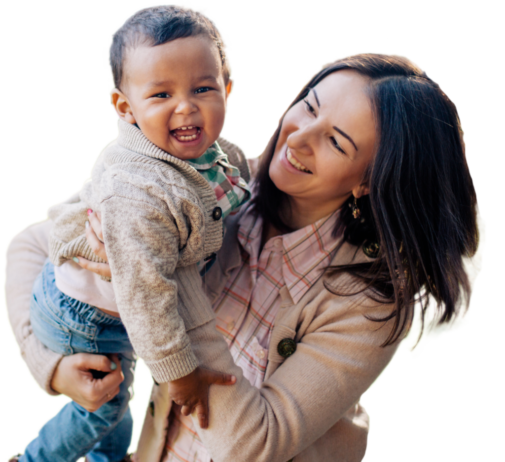 A photo of a woman holding a toddler and smiling with no background.